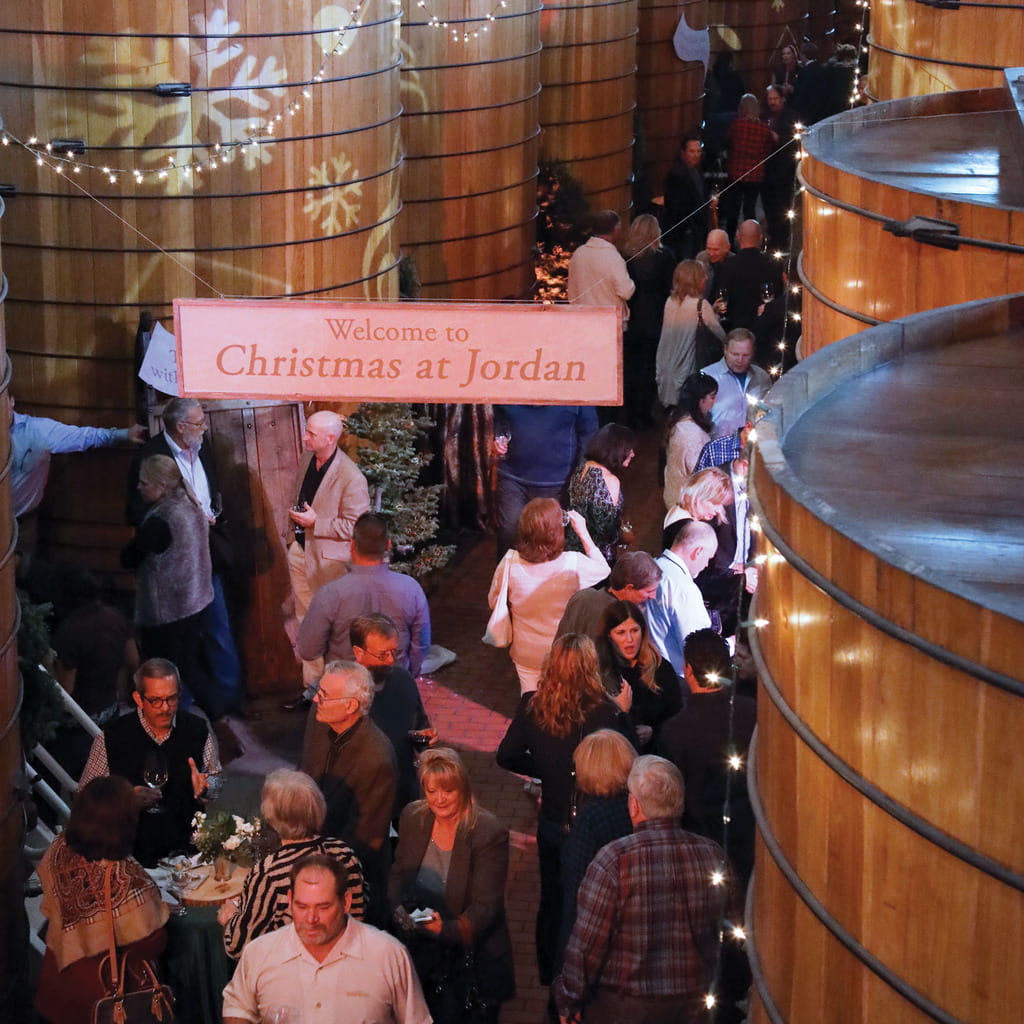 Guests walking around the towering oak tanks during Christmas at Jordan