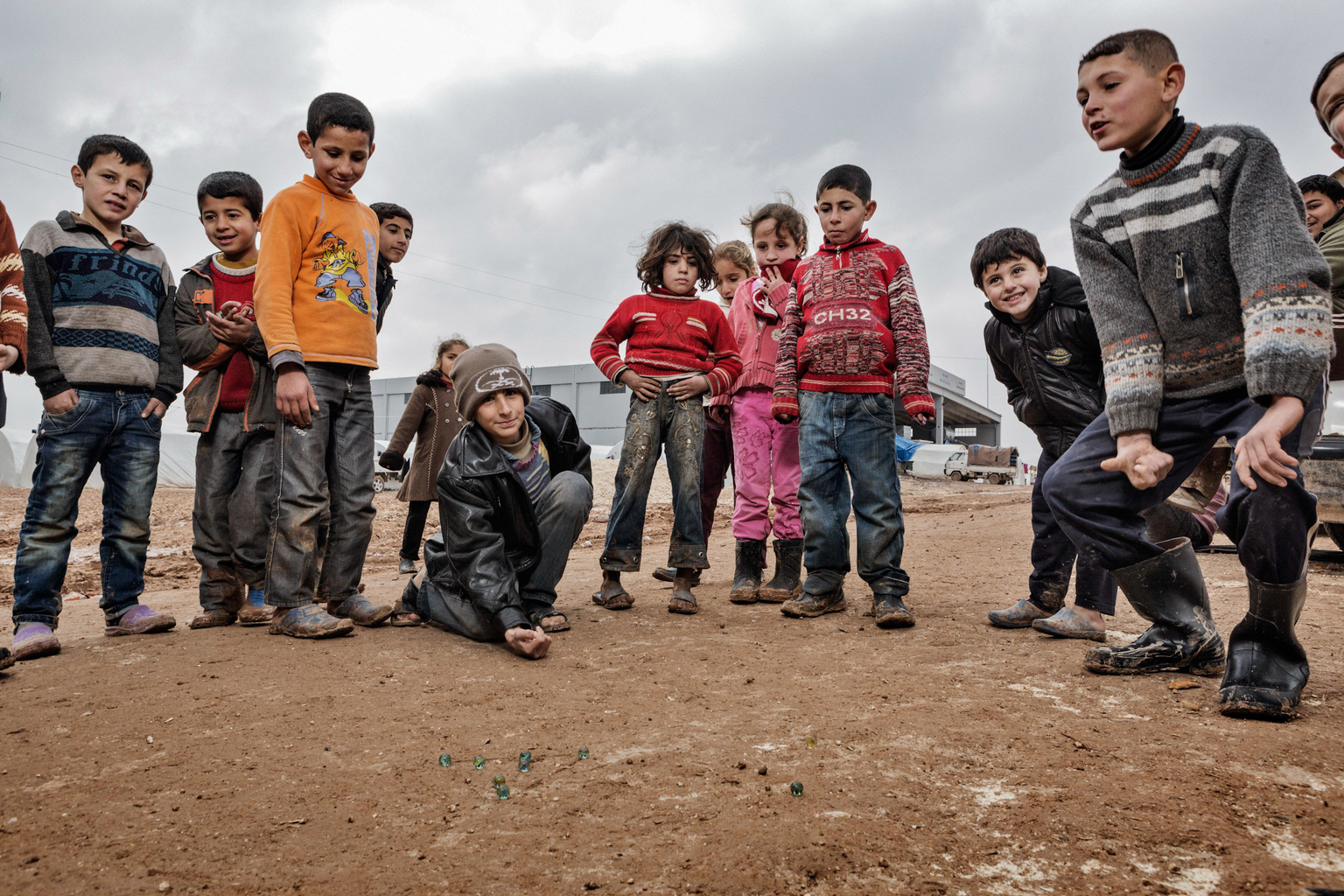 February 8, 2013, Bab al Salameh, Aleppo Province.
Kids play marbles in the Bab al Salemeh refugee camp next to the Turkish border.