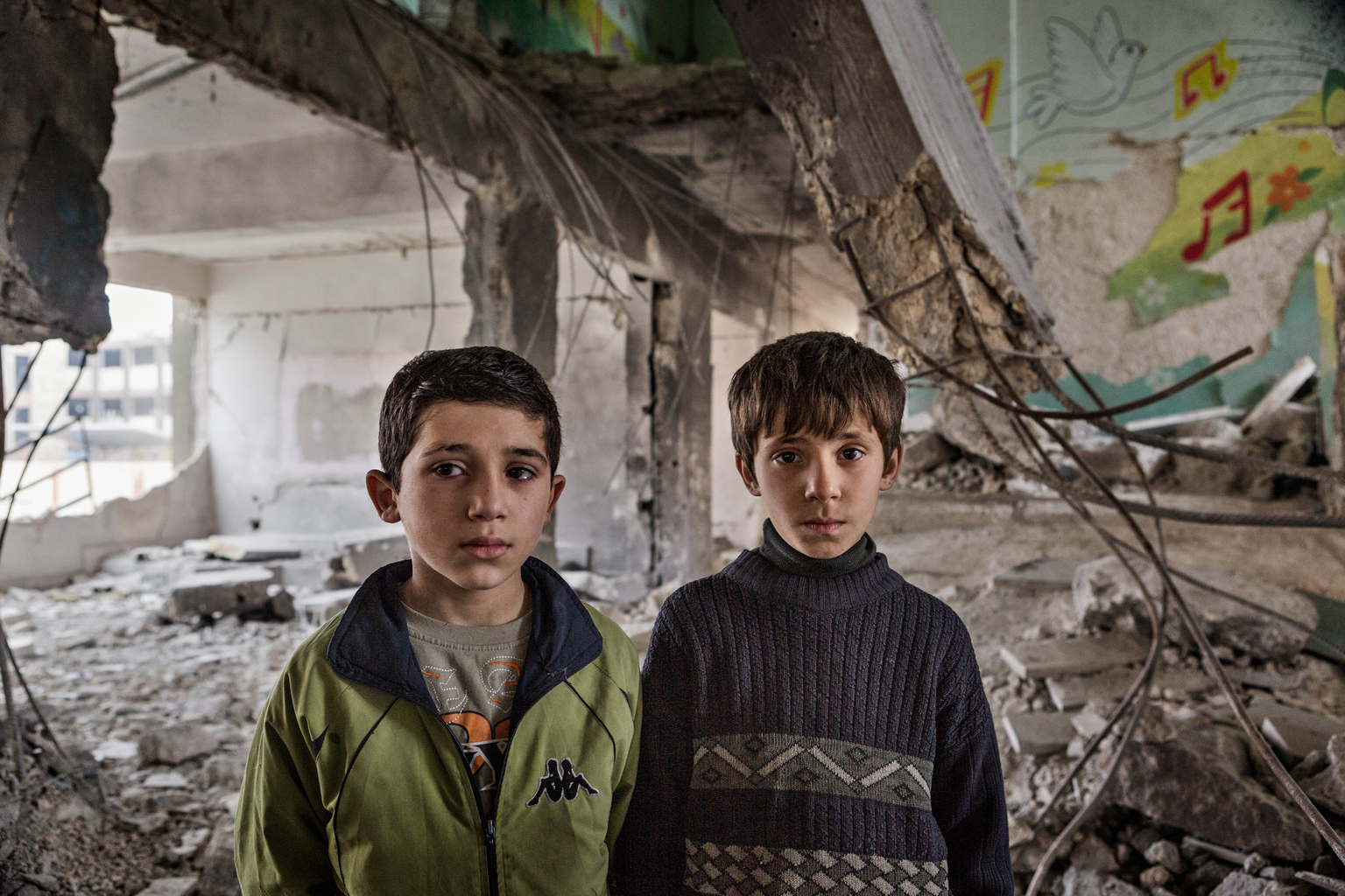 Febru ary 7, 2013, Tarik al Bab, Aleppo.
Two boys stand for a portrait in a damaged school building.