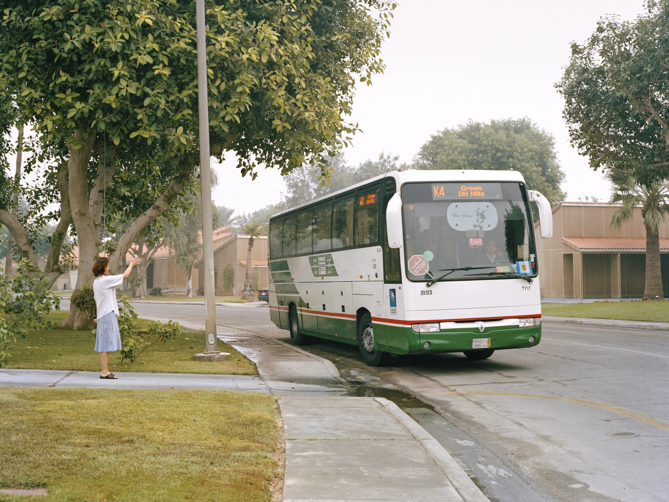 A mother waves goodbye to her daughter as she leaves for Dhahran Elementary School.