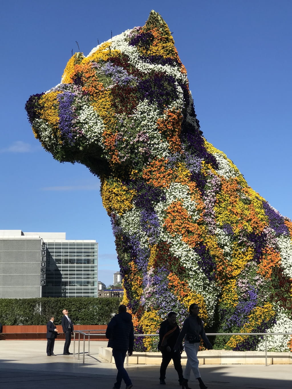 Amazing Living Dog greets you at Guggenheim. The wind blows the flowers making it look like moving fur on the dog.