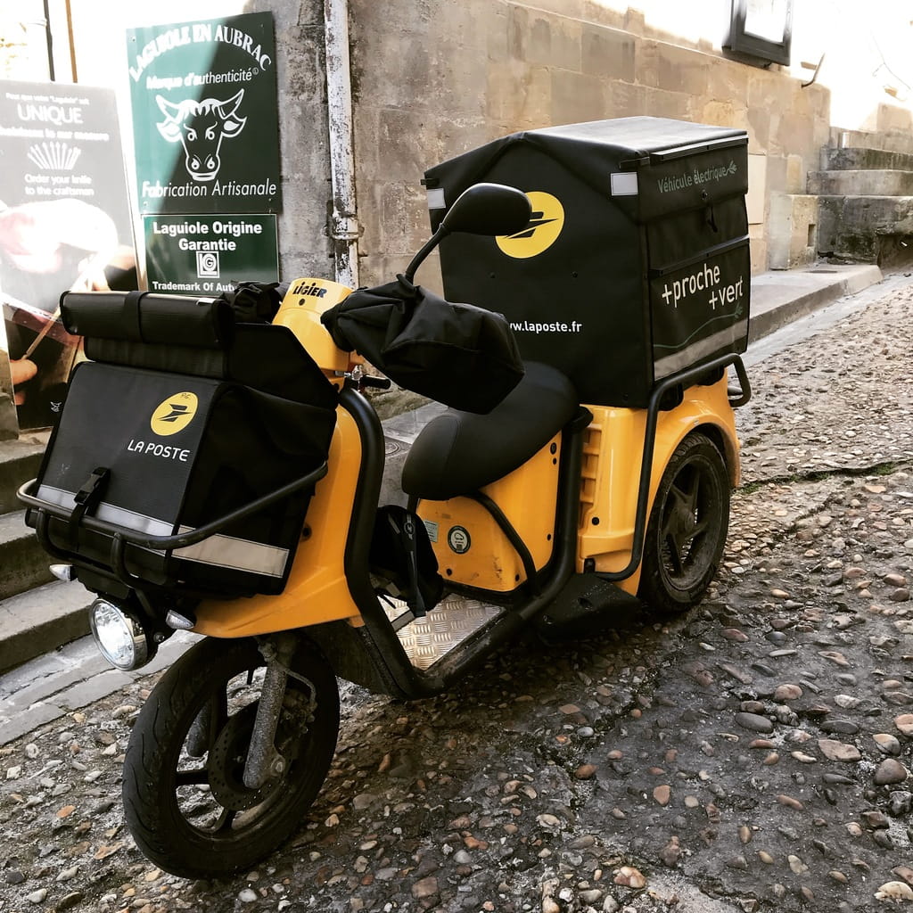 The village postal carrier.  Sharing expresso and delivering the mail.